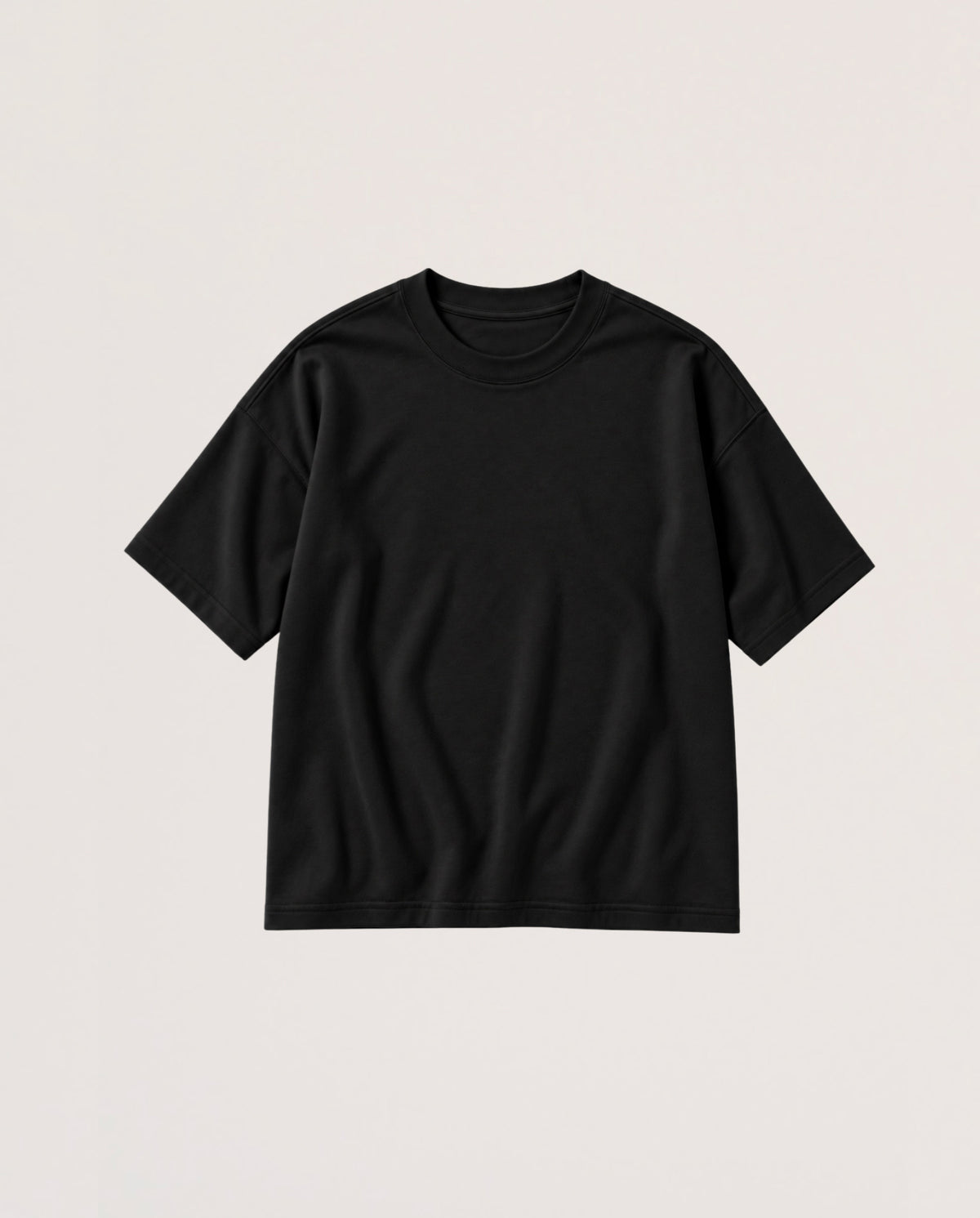 A plain black short-sleeve crewneck t-shirt laid flat against a light beige background.