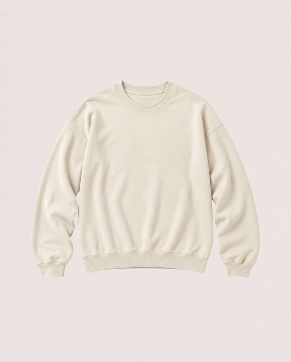 A cream-colored crewneck sweatshirt with long sleeves and ribbed cuffs and hem, displayed flat against a solid off-white background.
