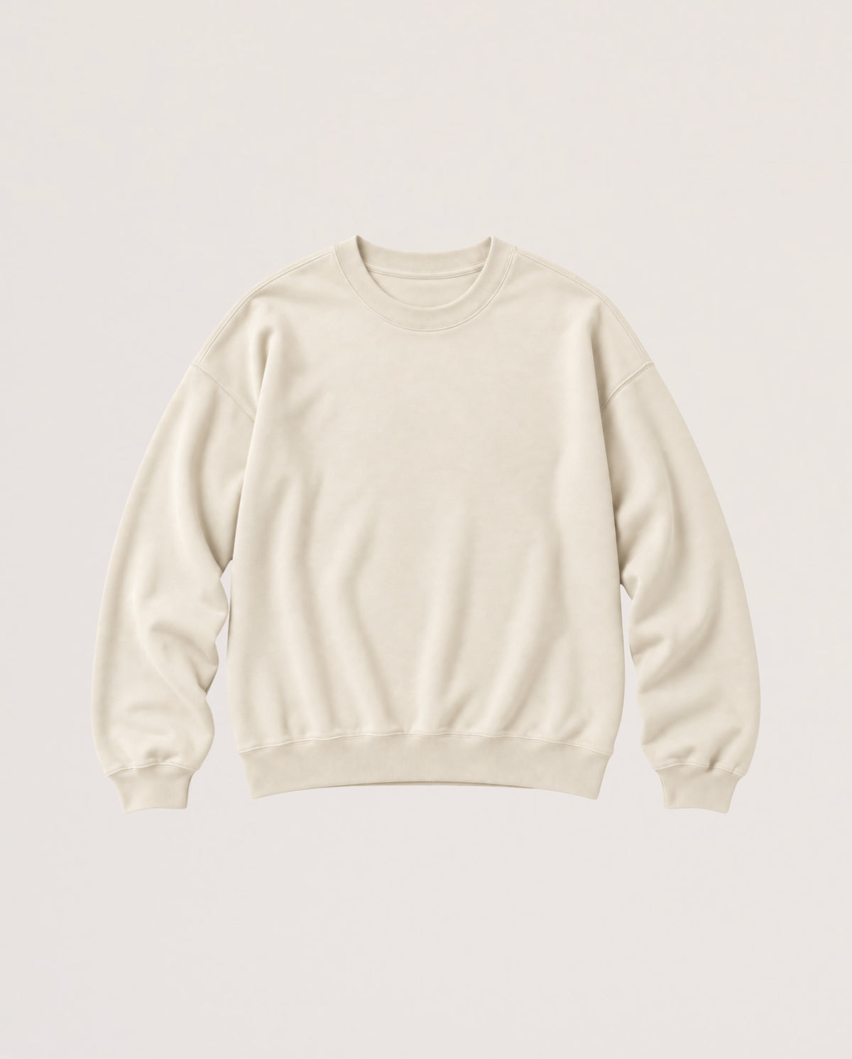 A cream-colored crewneck sweatshirt with long sleeves and ribbed cuffs and hem, displayed flat against a solid off-white background.