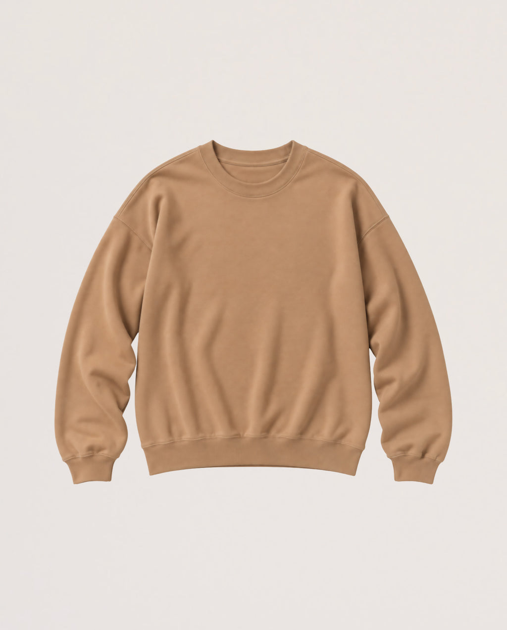 A plain crewneck sweatshirt in a warm tan or camel color, laid flat against a light off-white background.