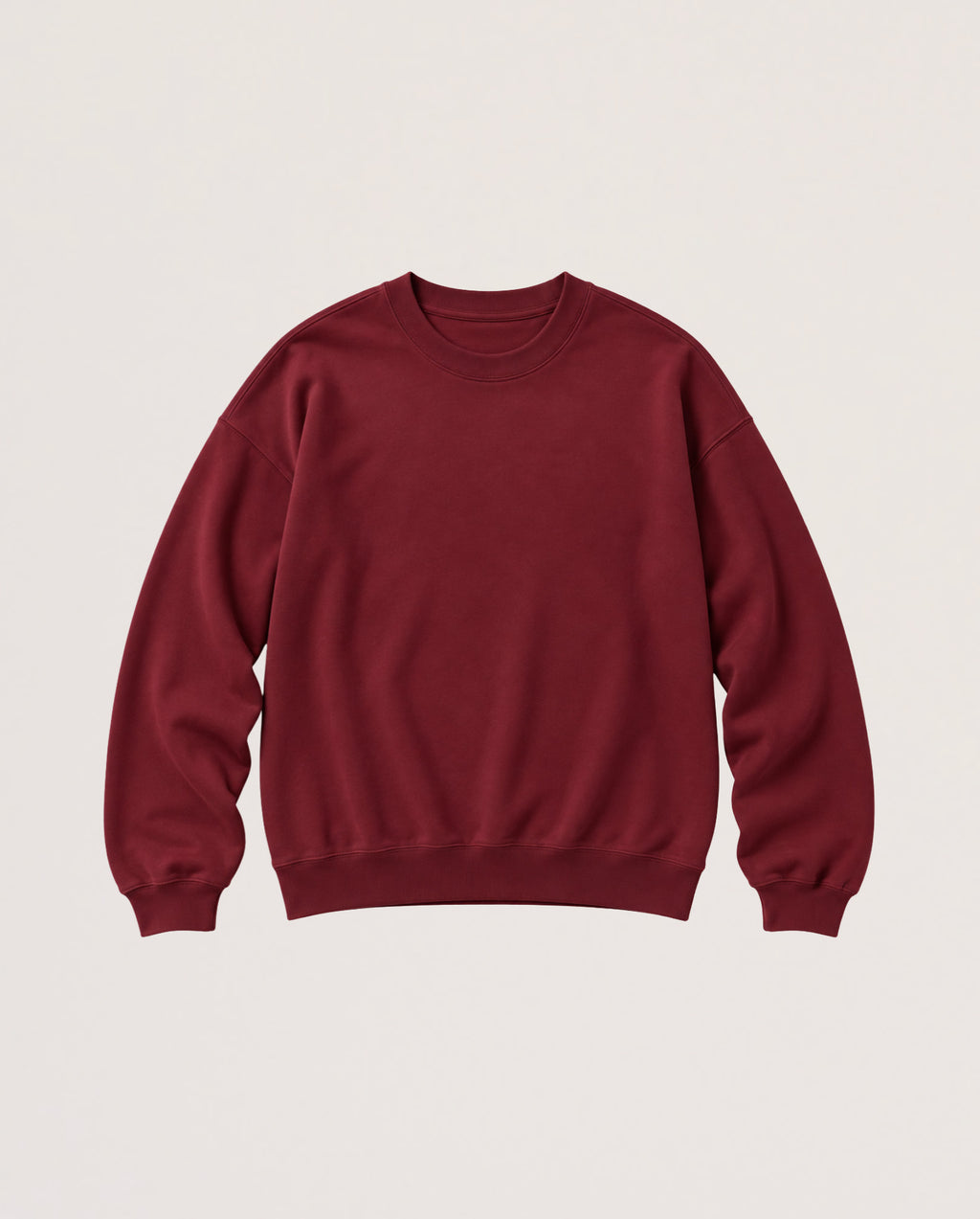 A crewneck sweatshirt in a deep burgundy red, laid flat against a light beige background.