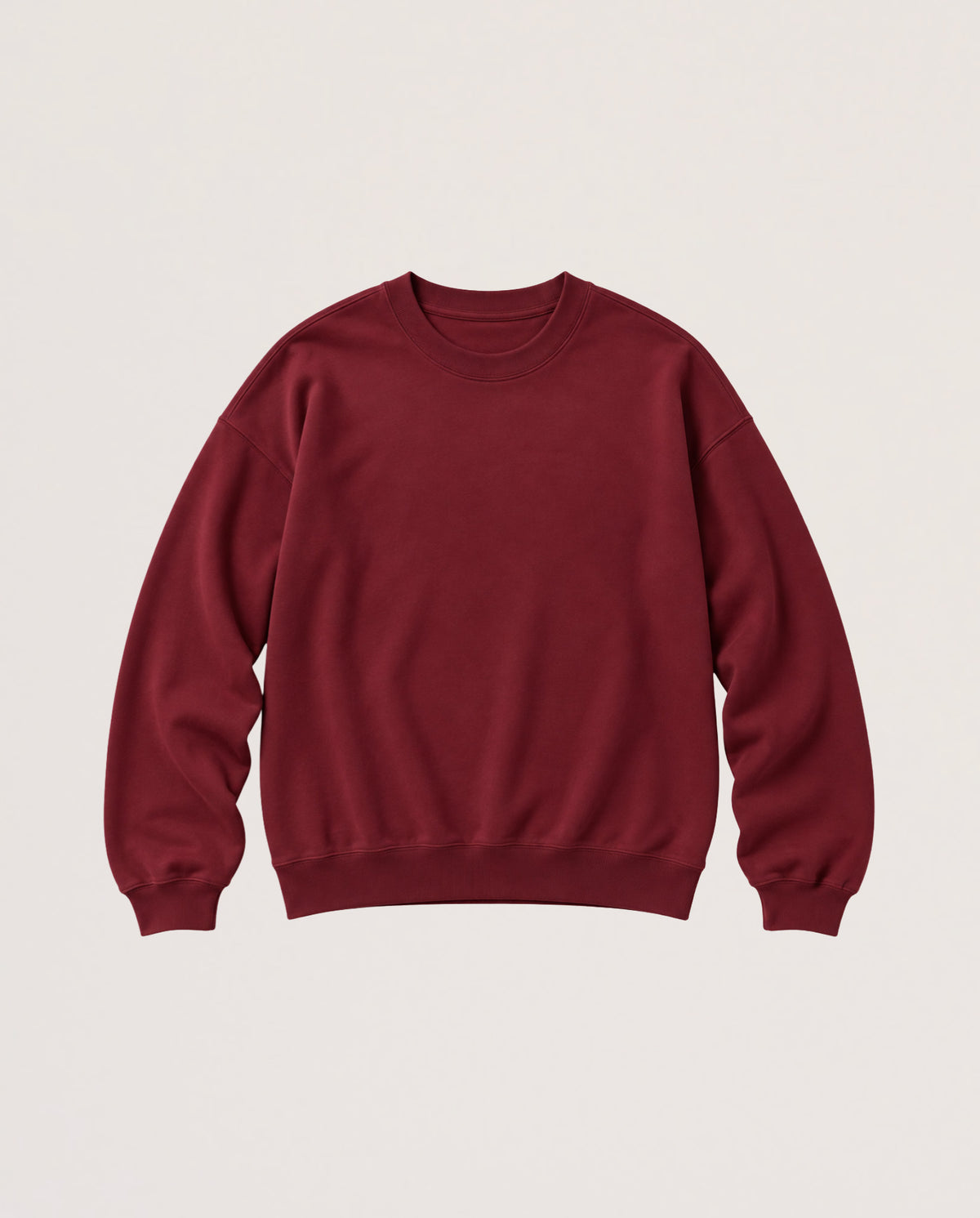 A crewneck sweatshirt in a deep burgundy red, laid flat against a light beige background.