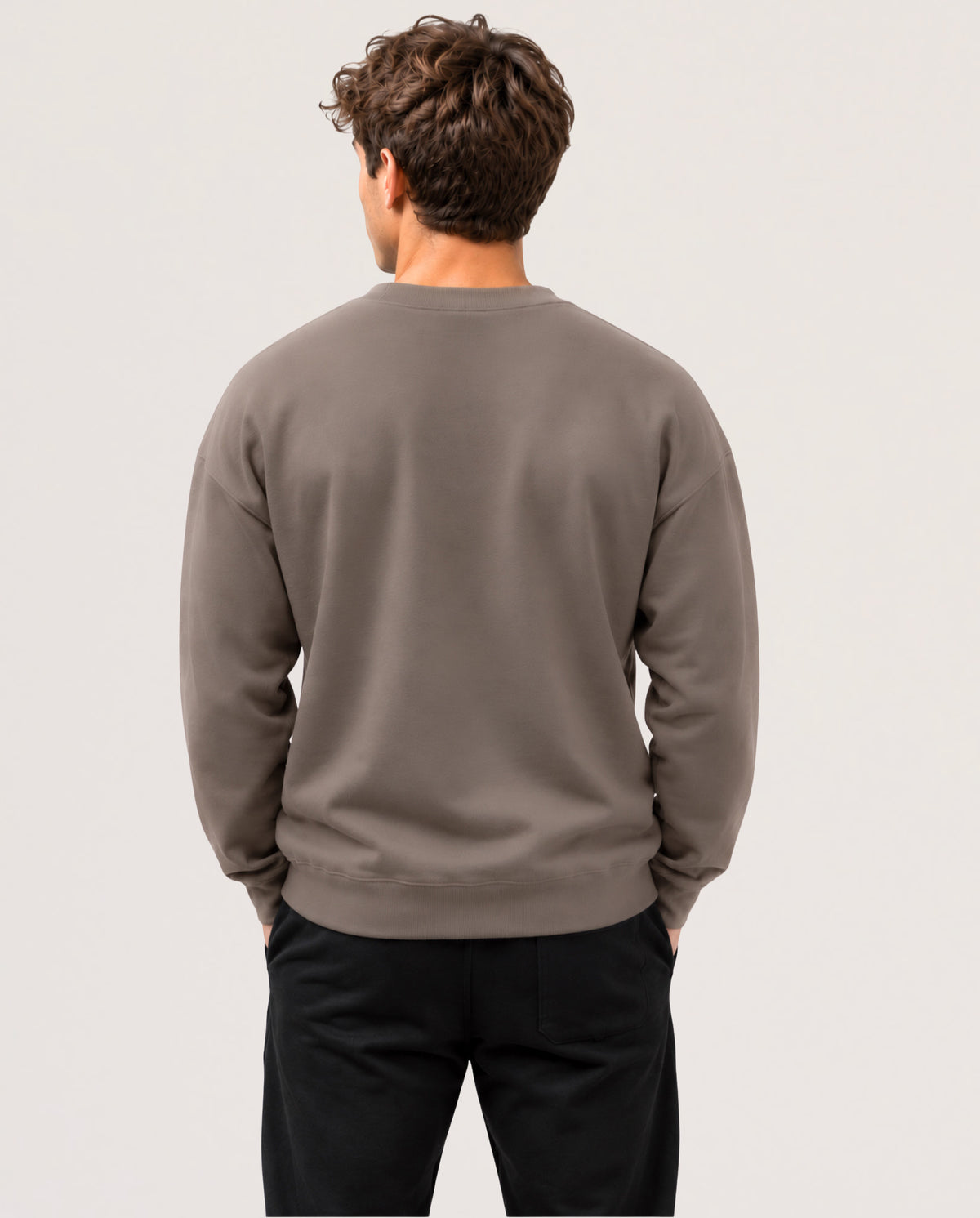 A model is seen from the back wearing a long sleeve shirt