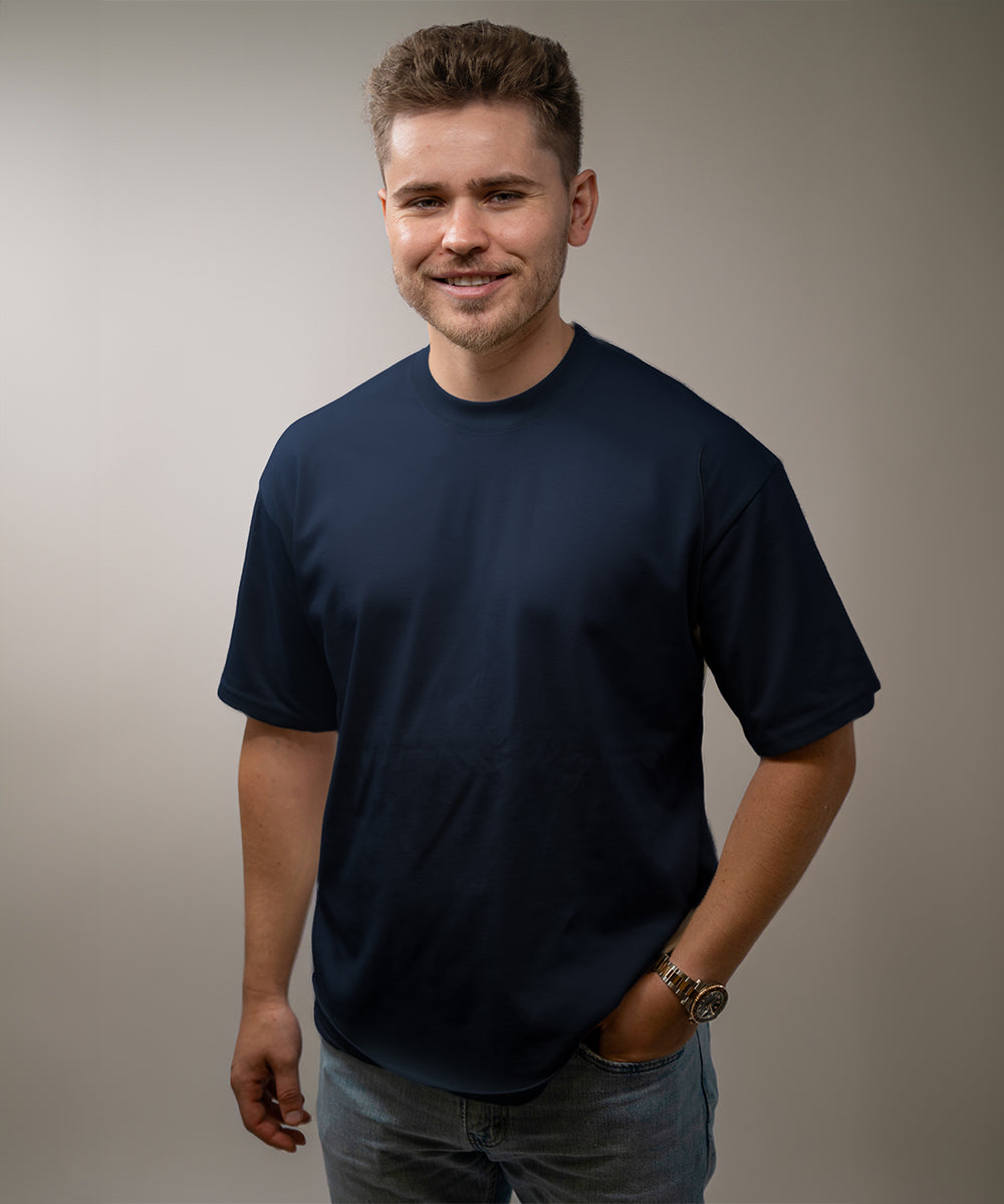 Man wearing a navy blue t-shirt against a plain background