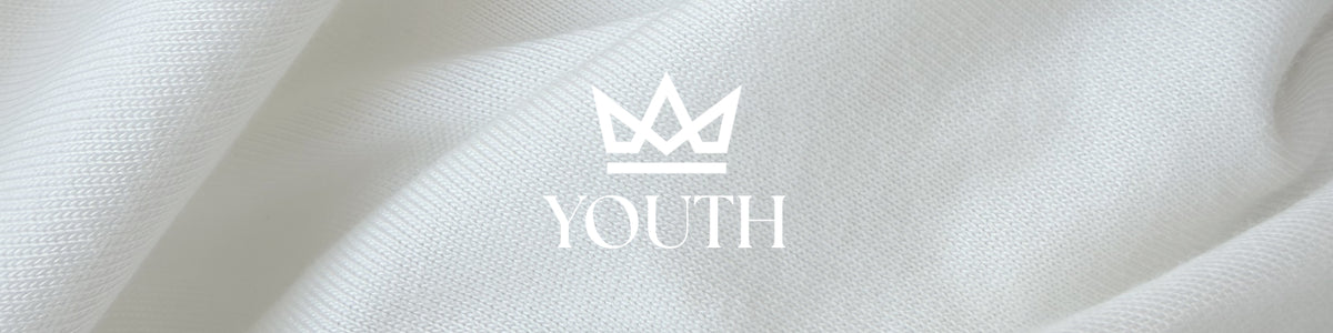 A close-up of white textured fabric with a white crown logo and the word YOUTH centered on it.